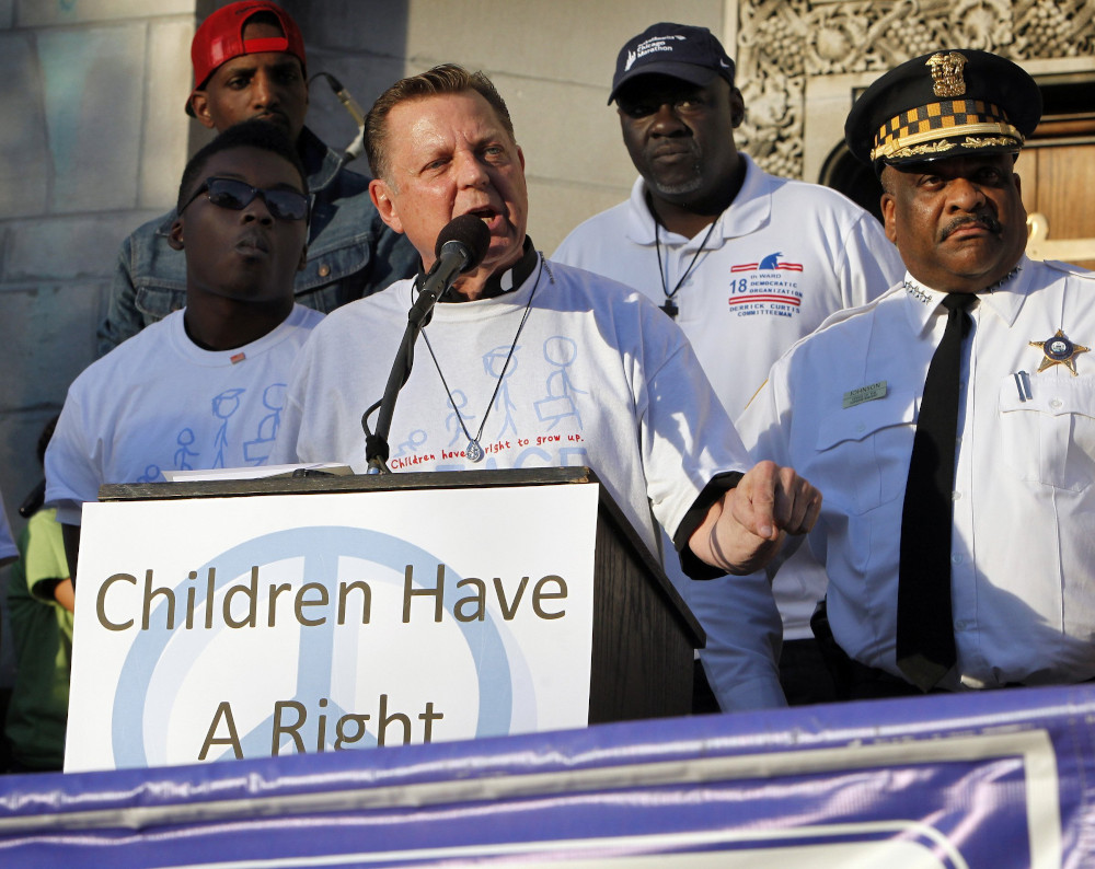 Fr. Michael Pfleger, senior pastor of the Faith Community of St. Sabina in Chicago, speaks at a June 17, 2016, rally to end gun violence. (CNS photo/Karen Callaway, Catholic New World)