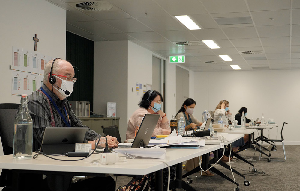 Attendees wearing protective masks and maintaining social distancing take part in the Oct. 6, 2021, session of Australia's Plenary Council in Brisbane. Most of the plenary was virtual because of COVID-19 lockdown rules, but in some areas people were allowed to gather in small groups. (CNS/Courtesy of Brisbane Archdiocese)