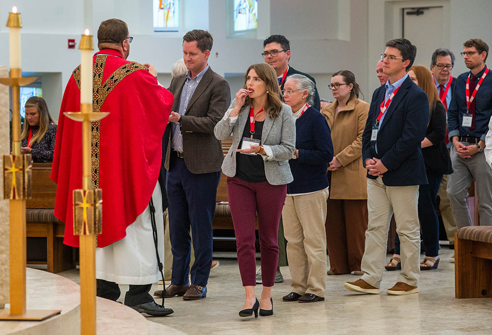 Participants in the conference on Vatican II and Catholic higher education receive Communion during Mass at the Chapel of the Holy Spirit at Sacred Heart University Oct. 14. (Sacred Heart University/Tracy Deer-Mirek)