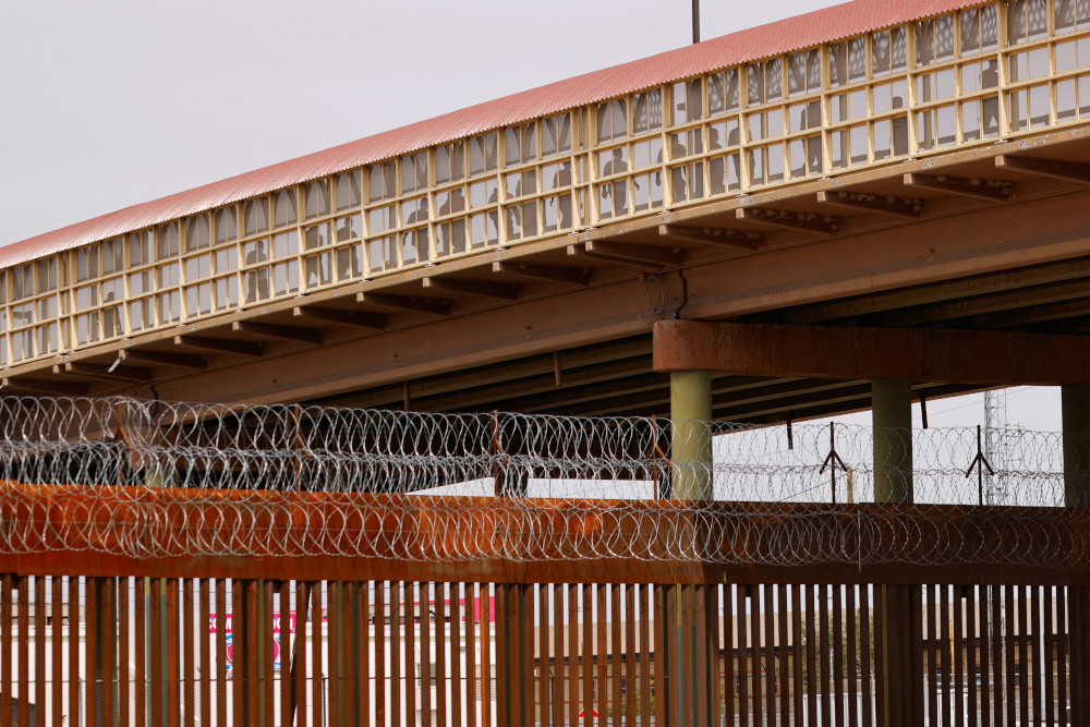 Venezuelan migrants expelled from the U.S. under Title 42 walk across the Lerdo-Stanton International border bridge to Ciudad Juarez, Mexico, Oct. 14, 2022.