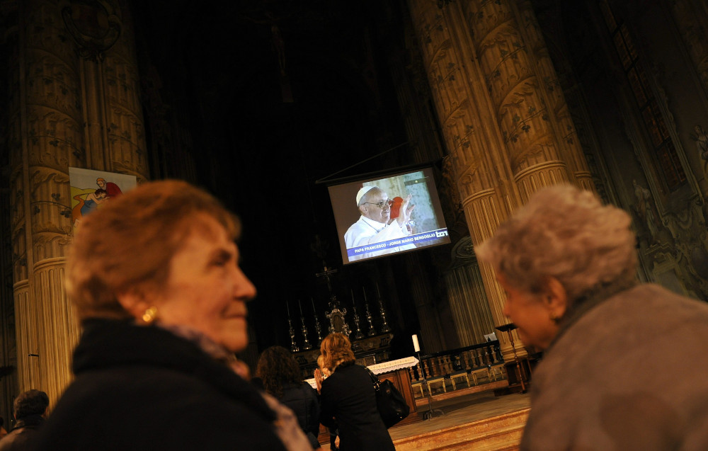 A TV screen in the Asti Cathedral shows Pope Francis March 13, 2013, the day he was elected at the Vatican. Pope Francis will travel to Asti Nov. 19-20 to help celebrate his cousin's 90th birthday and to celebrate Mass in the land where his father grew up. (CNS photo/Giorgio Perottino, Reuters)