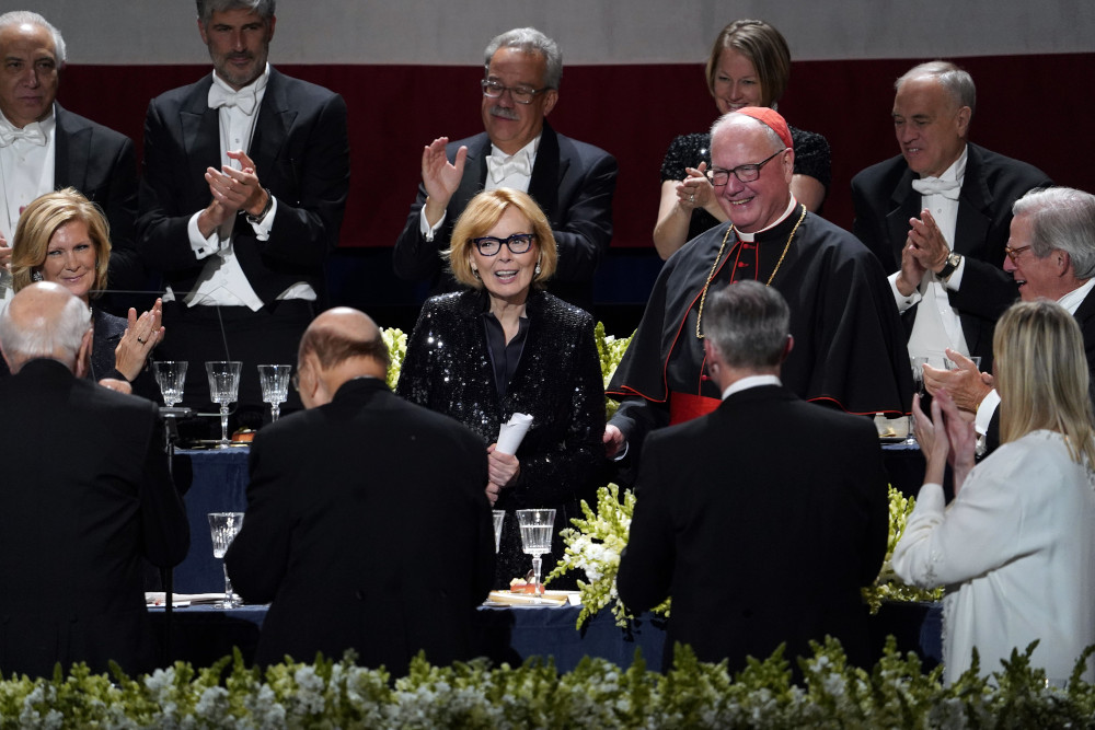 Peggy Noonan, Pulitzer Prize-winning Wall Street Journal columnist and former speech writer for President Ronald Reagan, is acknowledged by the audience, including New York Cardinal Timothy M. Dolan