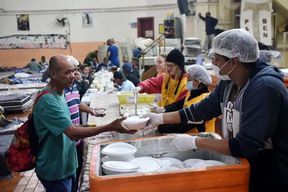 Franciscans in São Paulo serve meals to the homeless and hungry to Brazilians in a shelter May 19, 2022.  