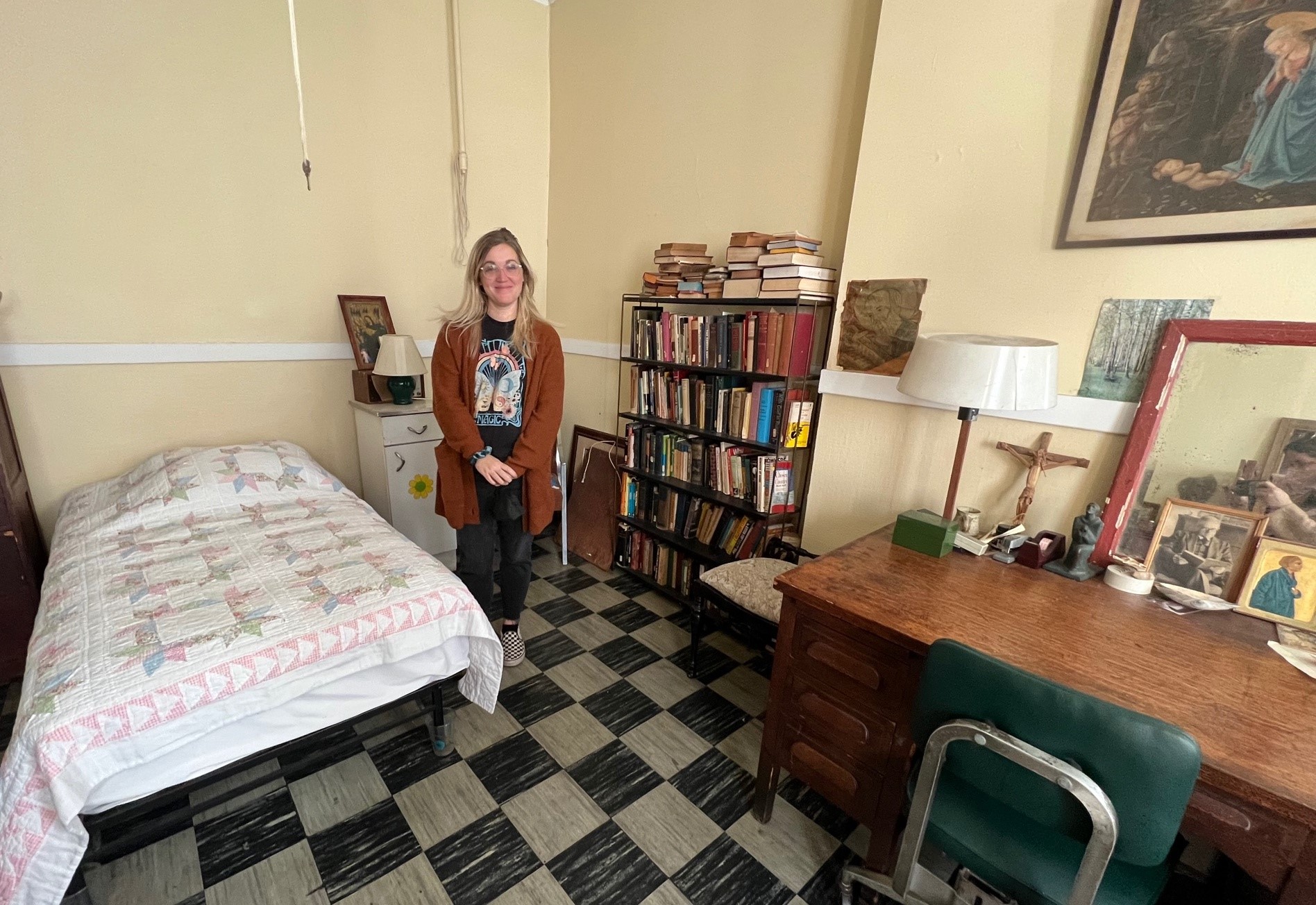 The author stands in Dorothy Day's former bedroom.