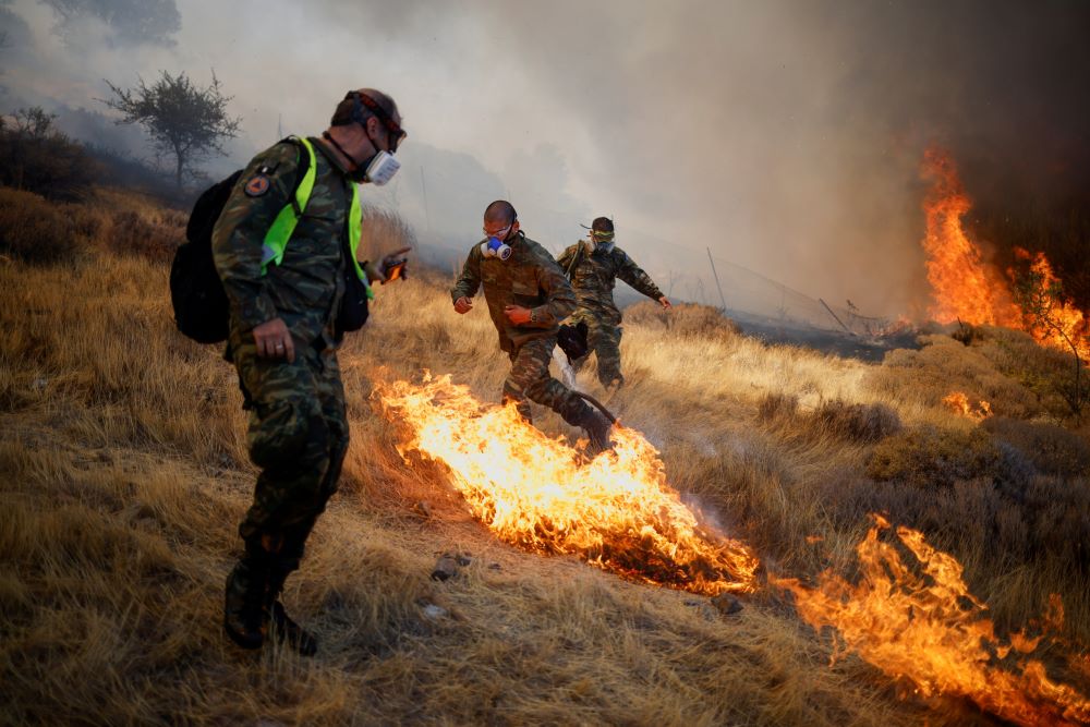 Firefighters battle wildfires in Greece.