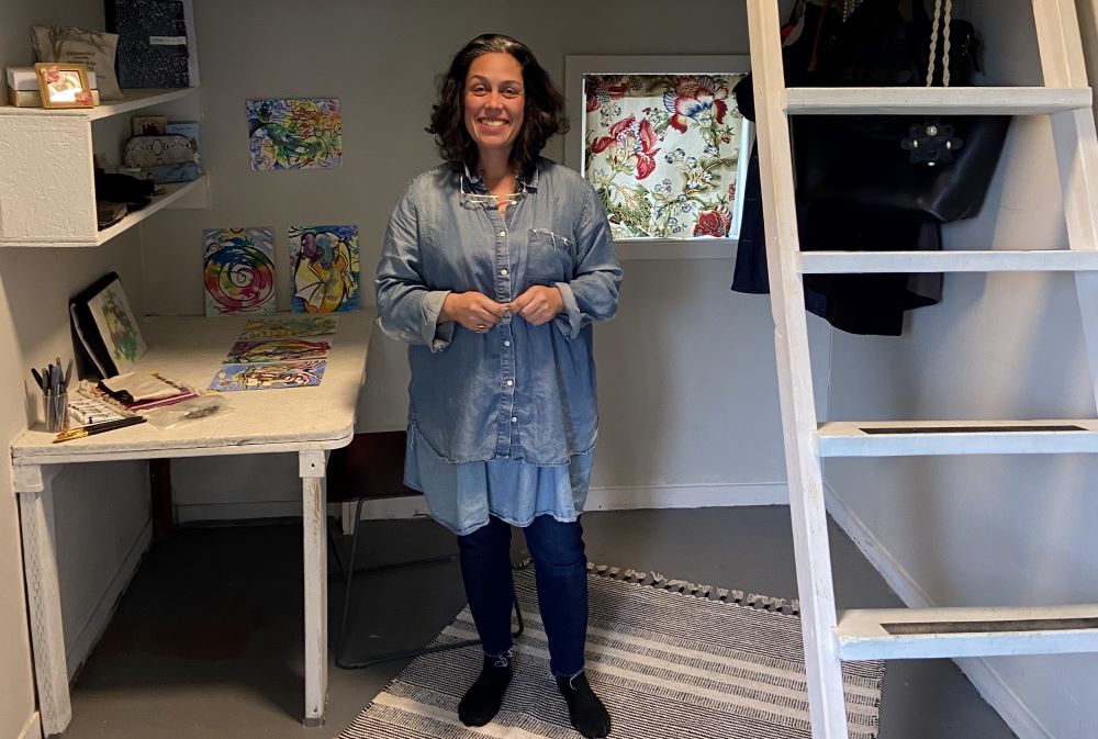 Melanie Rodriguez, a 51-year-old artist and former teacher, stands in her new tiny home at Kenton Women's Village.