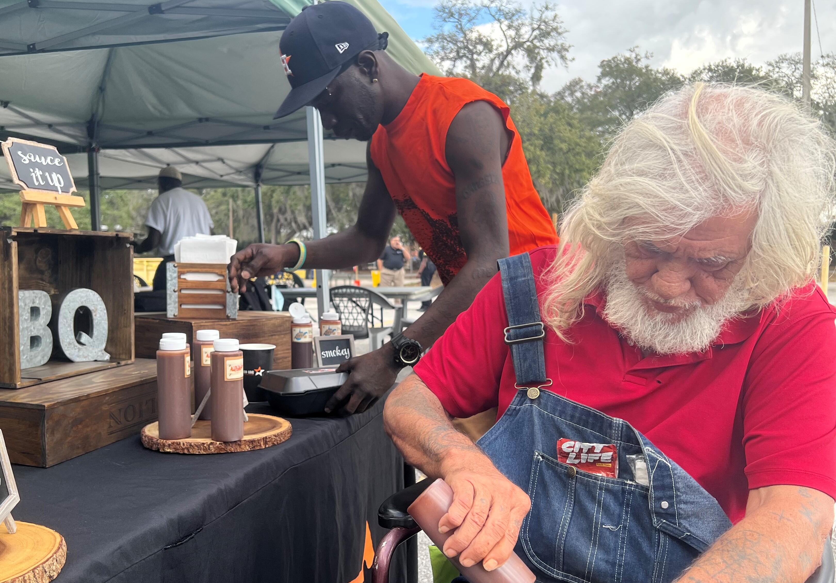 Men getting food at a picnic