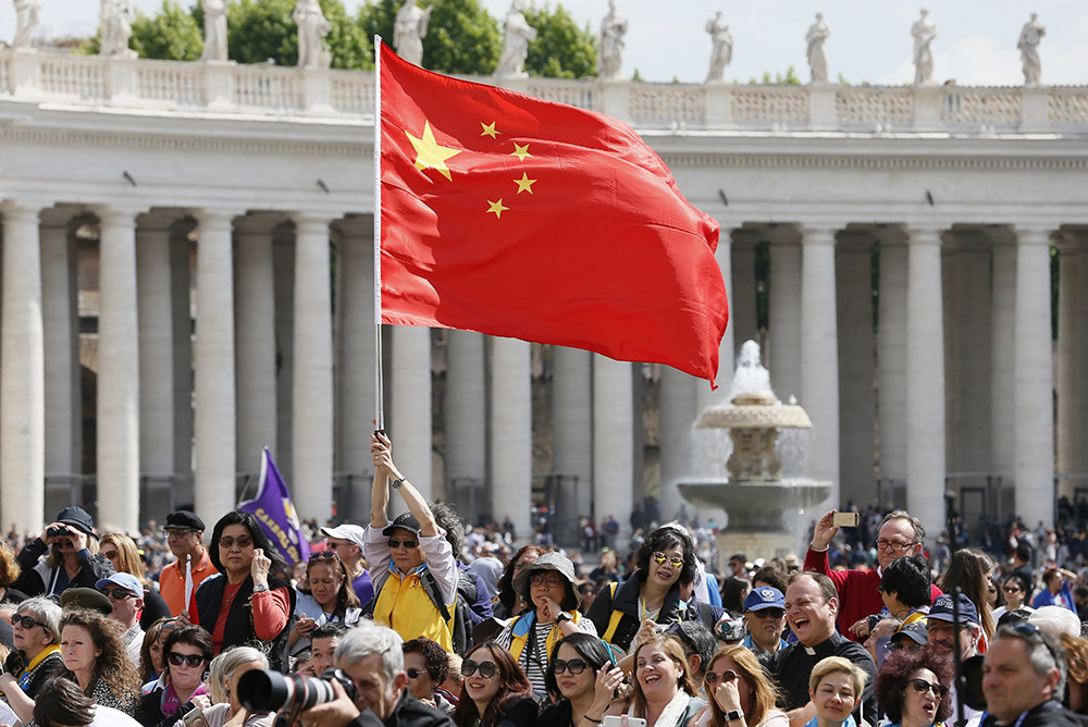 A man waves China's flag as Pope Francis leads his general audience in St. Peter's Square at the Vatican May 22, 2019. (CNS/Paul Haring)