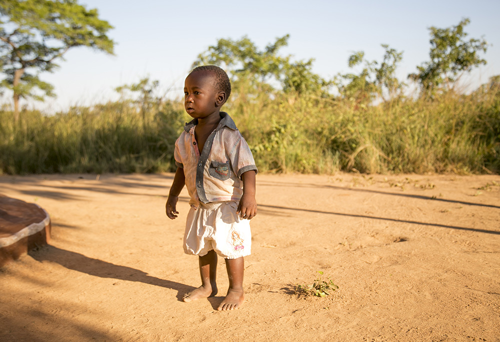 A Zambian child stands outside his home June 26, 2019, in the village of Ndombi in Zambia. (CNS/CRS/Michael Stulman)