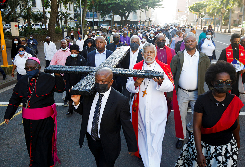 Clergymen carry a large cross during a Good Friday procession April 15 in Durban, South Africa. (CNS/Reuters/Rogan Ward)