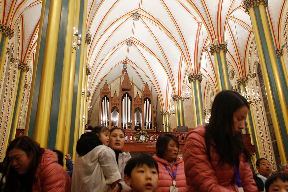 Worshippers attend a mass at Xishiku Cathedral, also known as Beitang, on Christmas Eve in Beijing in 2019. (CNS/Reuters/Florence Lo)