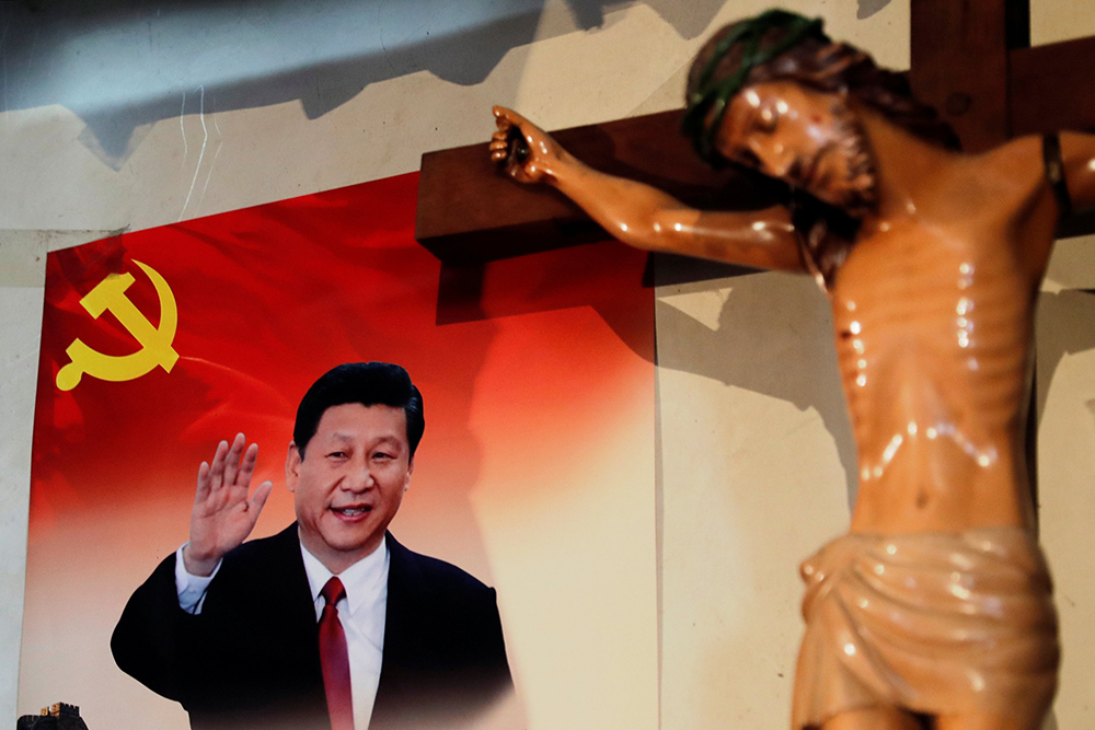 A poster of Chinese President Xi Jinping hangs next to a crucifix on the wall of the house of a Tibetan Catholic in Niuren village, in China's Yunnan province, in 2018. (CNS/Reuters/Tyrone Siu)