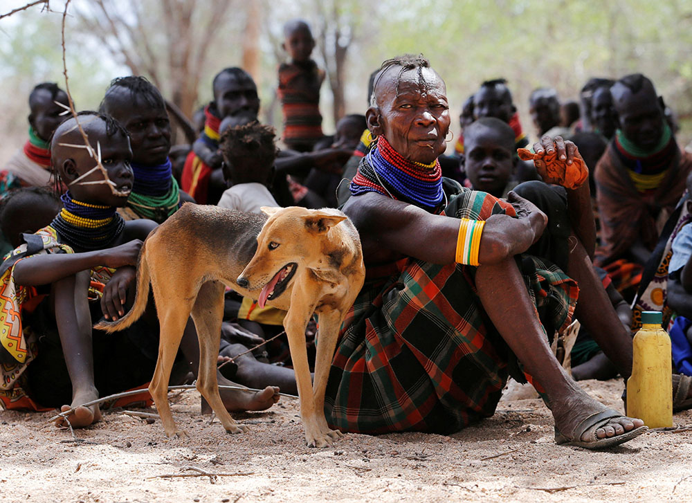A woman from the Turkana pastoralist community affected by the worsening drought sits by her dog at a medical clinic in Kakimat, Kenya Sept. 27. The clinic is run by the United Nations Children's Fund and the Kenyan Red Cross. (CNS/Reuters/Thomas Mukoya)