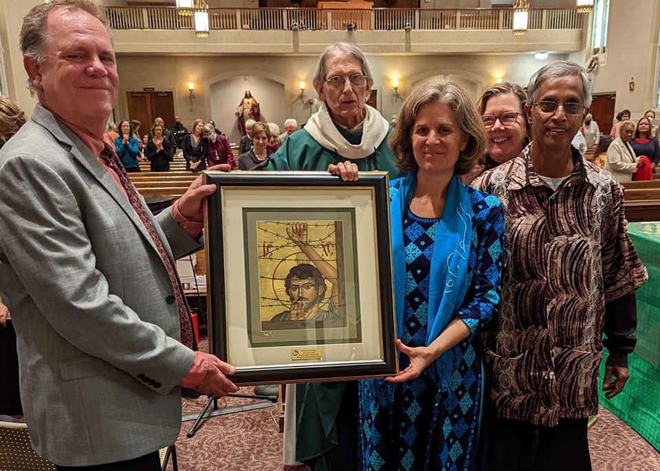 Maryknoll Lay Missioners Kirstin and Merwyn De Mello receive the 2022 Bishop John E. McCarthy Spirit of Mission Award during Mass at Holy Redeemer Church in Washington Oct. 23, 2022. Presenting the award were Ted Miles, left, executive director of Maryknoll Lay Missioners, and Mary Novak, second from right, who is executive director of Network, a Catholic social justice lobby. (CNS photo/Leroy Partlow, courtesy Maryknoll Lay Missioners)