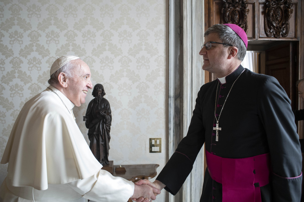 Pope Francis greets Archbishop Éric de Moulins-Beaufort of Reims, president of the French bishops' conference, during a meeting at the Vatican Dec. 13, 2021. 