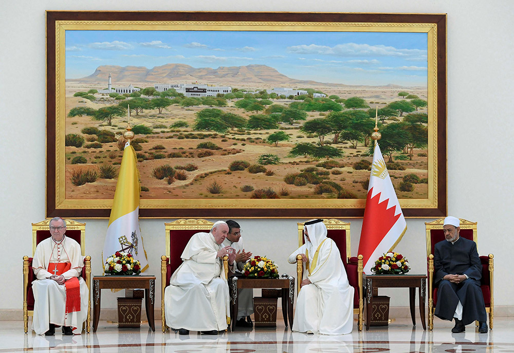 Pope Francis and Bahrain’s King Hamad bin Isa Al Khalifa speak at a farewell ceremony for the pope Nov. 6 at Sakhir air base in Awali. Also pictured is Cardinal Pietro Parolin, Vatican secretary of state, and Sheikh Ahmad el-Tayeb, grand imam of Egypt's Al-Azhar mosque and university. (CNS/Vatican Media via Reuters)