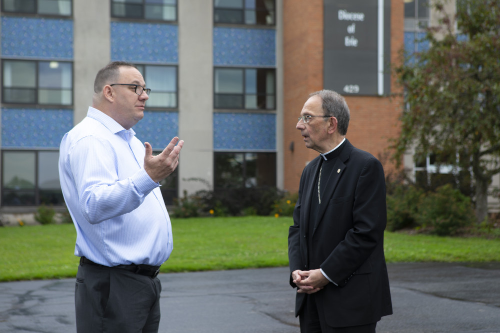 Bishop Lawrence T. Persico of Erie, Pa., speaks with Jim VanSickle of Pittsburgh, who told a Pennsylvania grand jury he was molested by a priest when he was a teenager in Bradford, Pa. VanSickle and the bishop spoke during an Aug. 21, 2018, news conference held in front of the Diocese of Erie's headquarters by members of the Survivors Network of those Abused by Priests, or SNAP.
