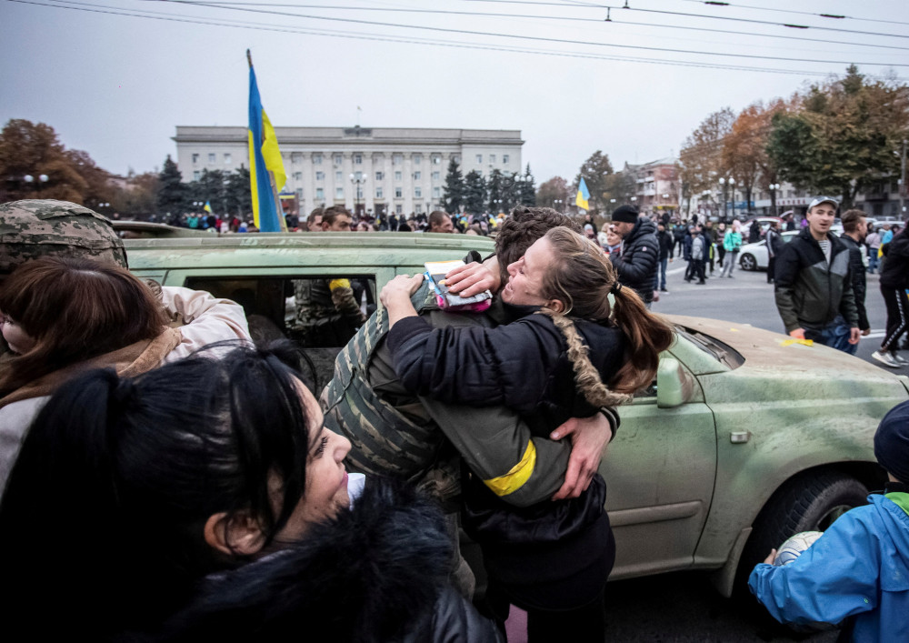 A local resident in Kherson, Ukraine, hugs a Ukrainian serviceman 