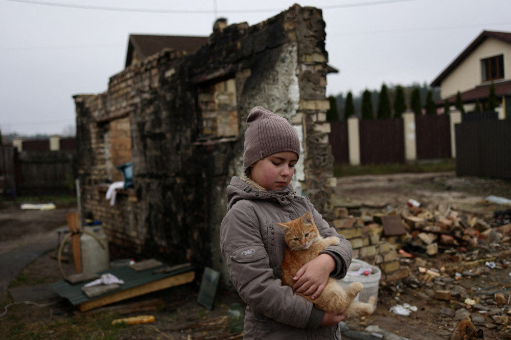 Yuliia Zaika, a 9-year old Ukrainian girl, holds her cat in the village of Moshchun near Kyiv, Ukraine, Nov. 8, 2022.