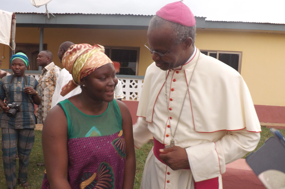 Cardinal Richard Kuuia Baawobr speaks with a woman