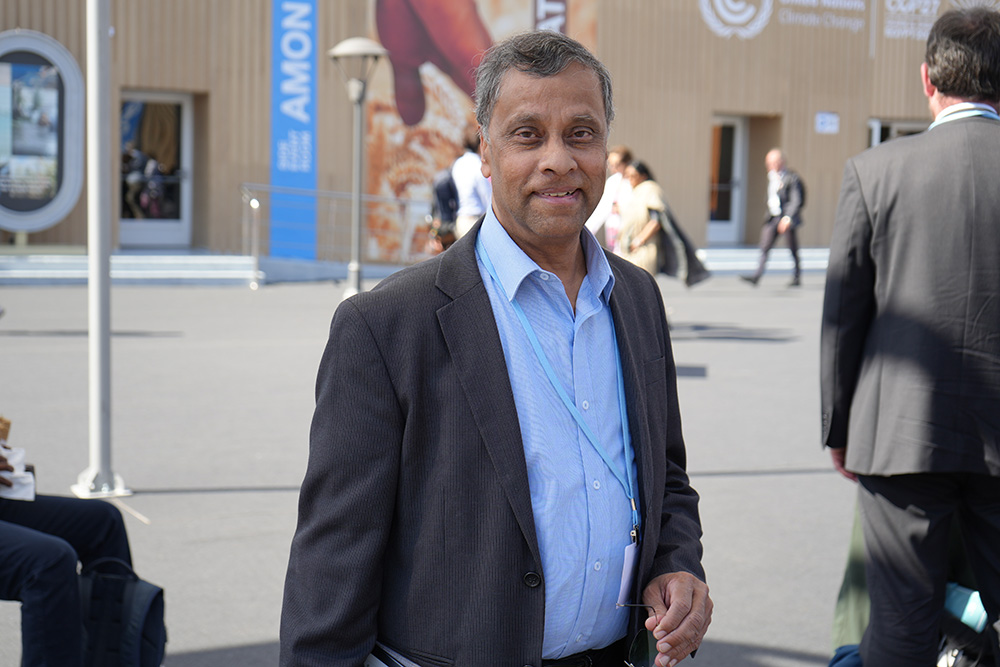 Aloysius John, the secretary general of Caritas Internationalis, poses for a photo at the climate change convening in Egypt's Red Sea resort of Sharm el-Sheikh, Nov. 10. (EarthBeat photo/Doreen Ajiambo)