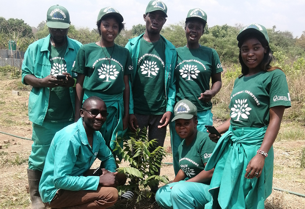 Youth Climate Champions, supported by Catholic Relief Services, plant trees and advocate for a move away from charcoal burning, which is worsening deforestation in Zambia. (Tawanda Karombo)