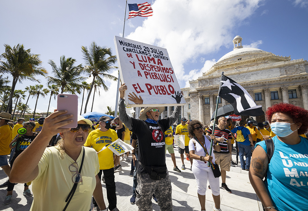 People protest against the Luma Energy company in front of the Puerto Rico Capitol July 20 in San Juan, Puerto Rico. (AP photo/Alejandro Granadillo)