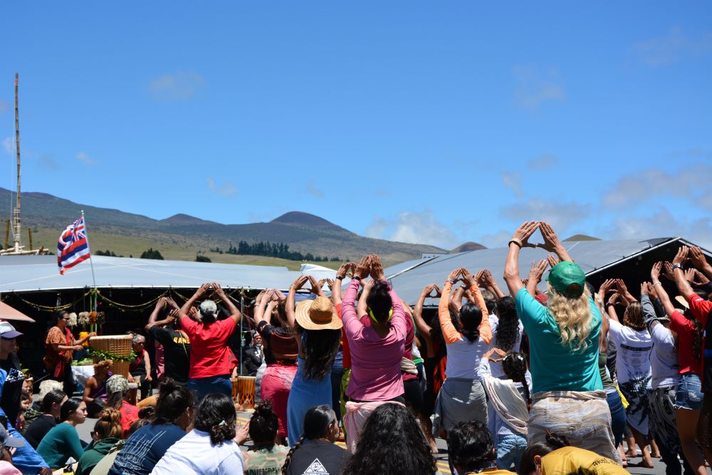 Activists who oppose the construction of the Thirty Meter Telescope, who prefer the term “protectors,” perform traditional Hawaiian dances at the base of Mauna Kea in Hawaii in 2019. (RNS/Jack Jenkins)