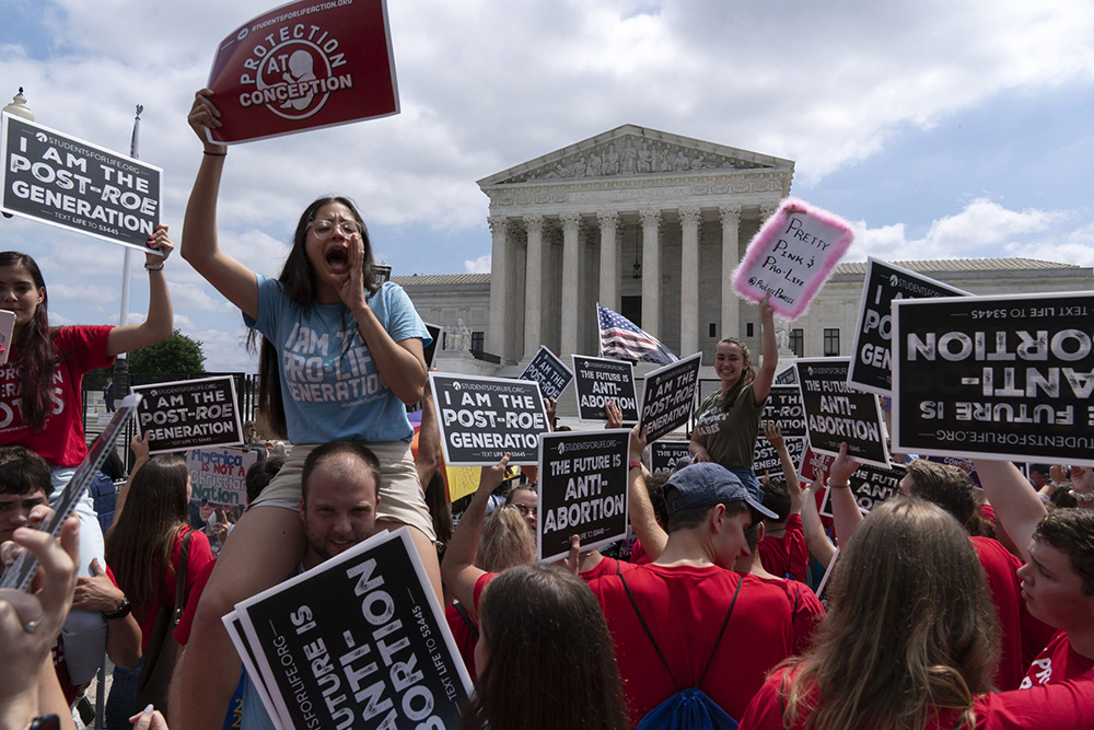 Anti-abortion protesters celebrate outside the Supreme Court in Washington June 24 in the wake of the court's decision in Dobbs v. Jackson Women's Health Organization. (RNS/AP/Jose Luis Magana)