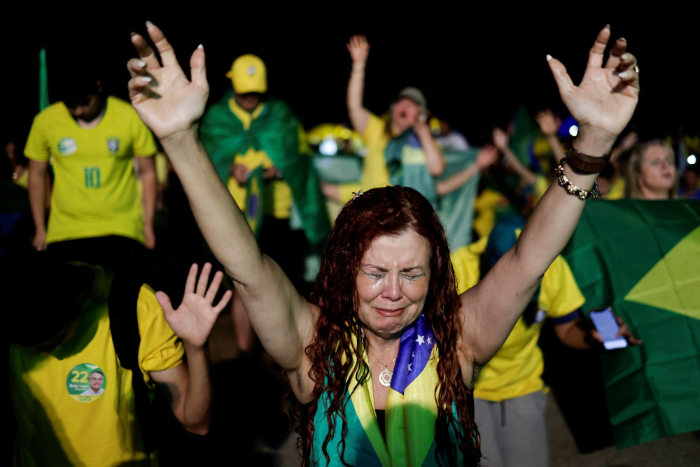 A supporter of Brazil's president and presidential candidate, Jair Bolsonaro, cries after former President Luiz Inacio Lula da Silva was proclaimed the winner of the presidential runoff, in Brasilia, Brazil, Oct. 30. (CNS/Reuters/Ueslei Marcelino)