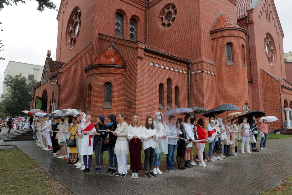Women form a human chain in front of Sts. Simon and Helena Church in Minsk, Belarus, Aug. 27, 2020, during a protest against presidential election results. (CNS/Reuters/Vasily Fedosenko)
