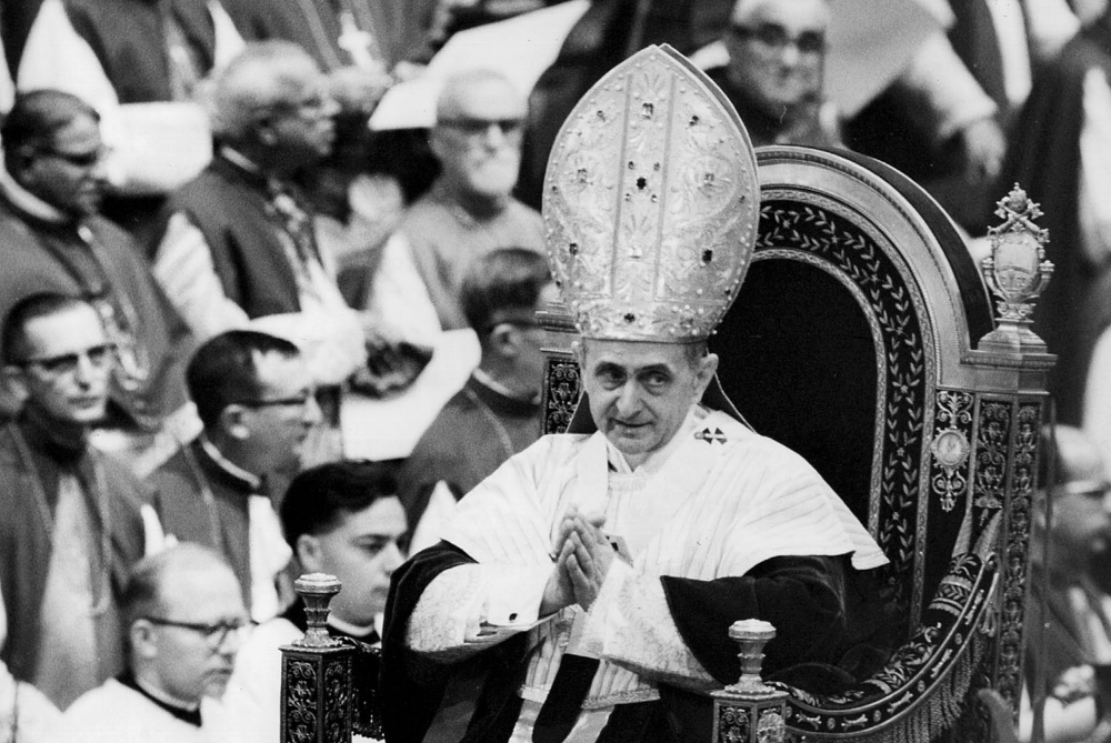 Pope Paul VI makes his way past bishops during a session of the Second Vatican Council in 1964. (CNS file photo) 