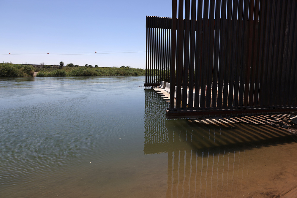 The Colorado River flows past the border wall in Andrade, California, April 19, 2021. (CNS/Reuters/Jim Urquhart)