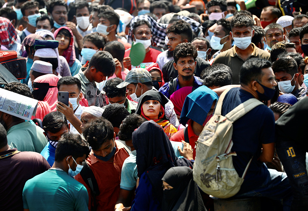 Migrants wait to board an overcrowded ferry to get home to celebrate Eid al-Fitr in Munshiganj, Bangladesh, May 10, 2021, after restrictions on public transportation were relaxed during the COVID-19 pandemic. (CNS/Reuters/Mohammad Ponir Hossain)