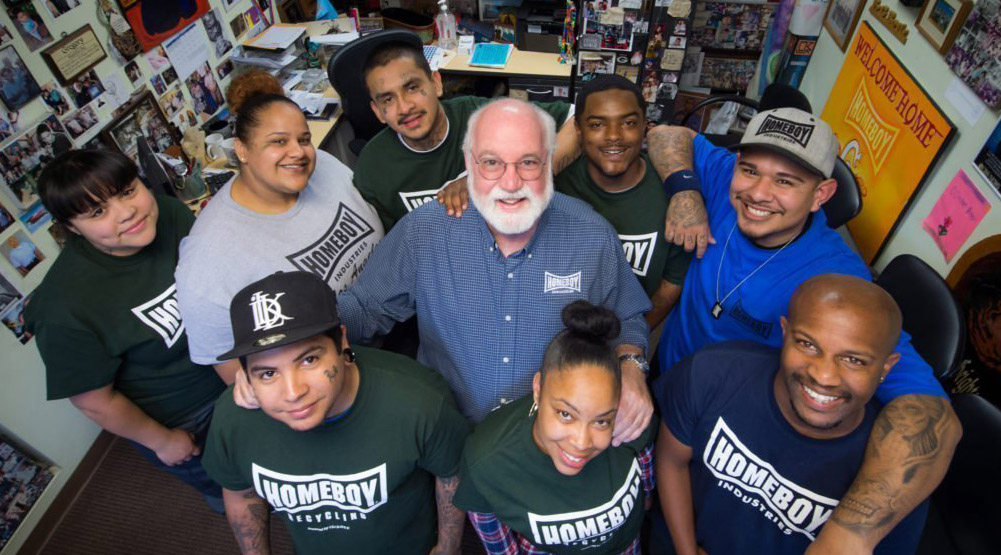 Jesuit Fr. Greg Boyle, founder of Homeboy Industries in Los Angeles, poses for a photo with trainees in this undated photo. Homeboy Industries is a project that works with former gang members in the Los Angeles area. (CNS/Courtesy of Homeboy Industries)