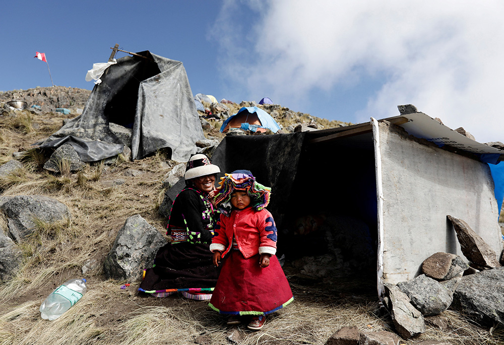 A woman from the Indigenous community of Huancuire and her daughter camp with others near the Las Bambas copper mine in Apurimac, Peru May 9, 2022. It was part of a protest to demand that their ancestral lands be returned to the communities. (CNS/Reuters/Angela Ponce)
