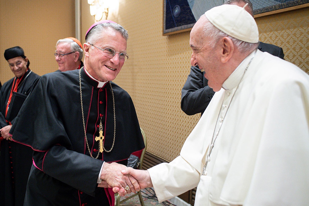 Pope Francis greets Archbishop Timothy Broglio, newly elected president of the U.S. Conference of Catholic Bishops, during a meeting with the presidents and coordinators of the regional assemblies of the Synod of Bishops at the Vatican Nov. 28, 2022. (CNS/Vatican Media)