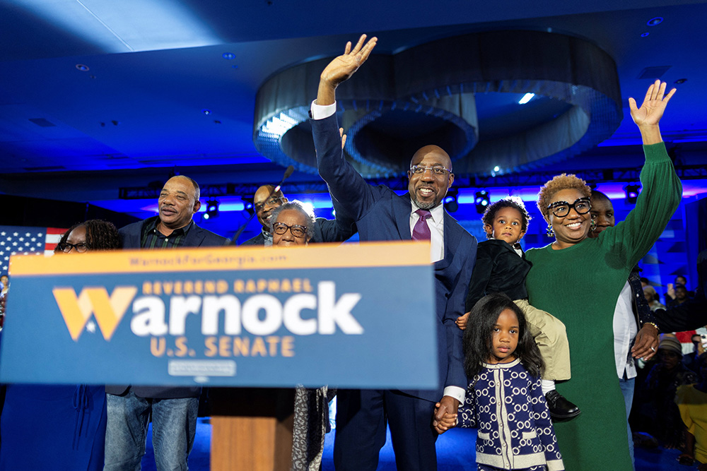 Sen. Raphael Warnock, D-Georgia, is joined on stage by family members during an election night party in Atlanta Dec. 6, after his projected win in the Georgia midterm runoff election over Republican challenger Herschel Walker. (CNS/Reuters/Carlos Barria)