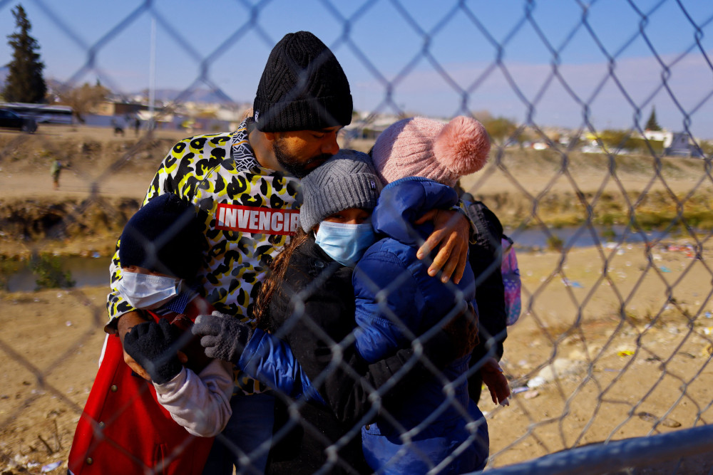 A family of Colombian migrants hug one another upon arriving at the U.S. border in El Paso, Texas, Dec. 19, 2022, to request asylum in the United States. (CNS photo/Jose Luis Gonzalez, Reuters)