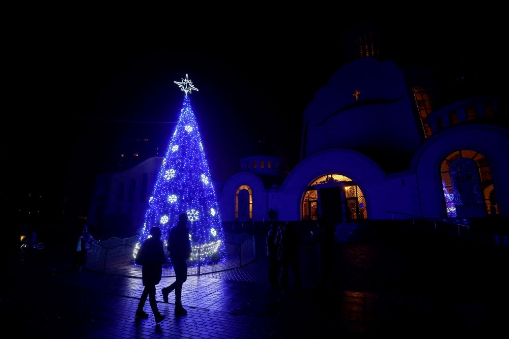A Christmas tree is seen in front of an Orthodox cathedral during a service in Kyiv, Ukraine, Dec. 24, 2022. (CNS/Reuters/Valentyn Ogirenko)