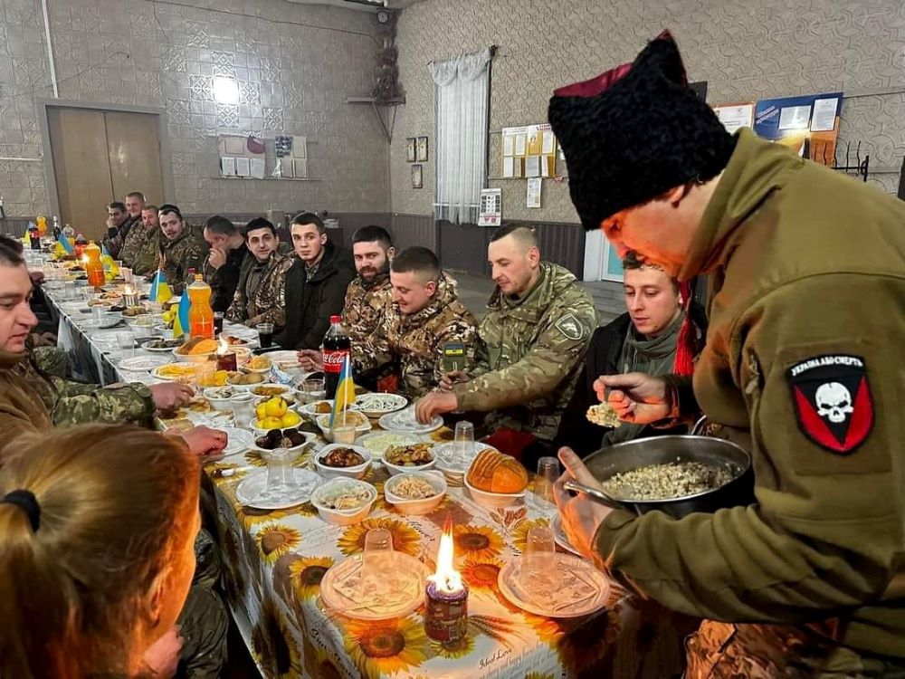 Ukrainian service members have their festive Christmas dinner at an unspecified location in Ukraine, in this handout picture released by the Ukrainian Armed Forces press service Dec. 25, 2022. (CNS/Reuters/Ukrainian Armed Forces)