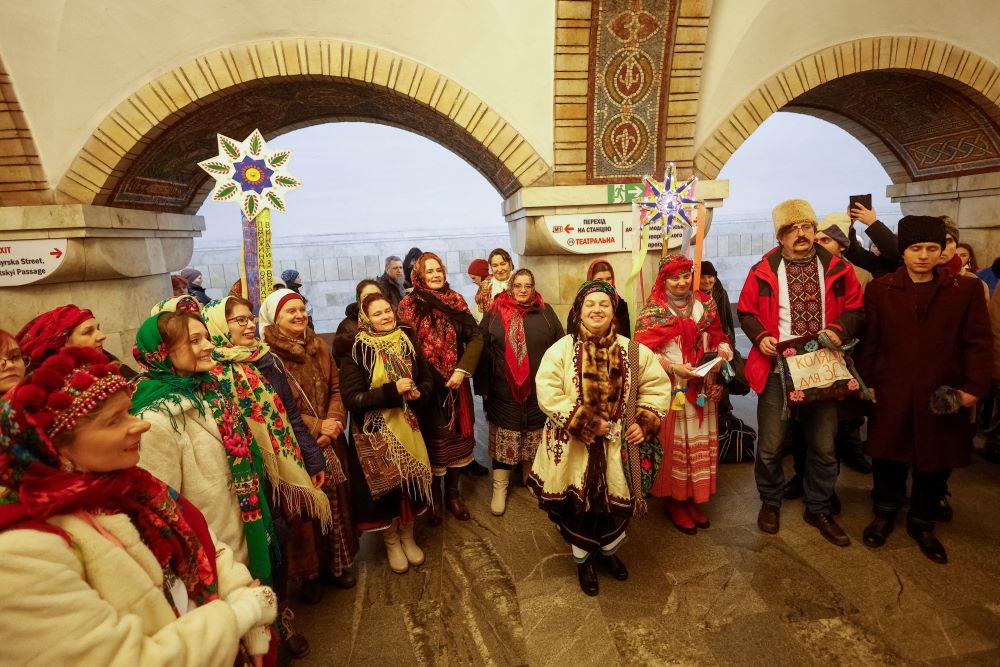 Local residents sing Christmas carols during an air raid alarm inside a metro station in Kyiv, Ukraine, Dec. 25, 2022. (CNS/Reuters/Valentyn Ogirenko)