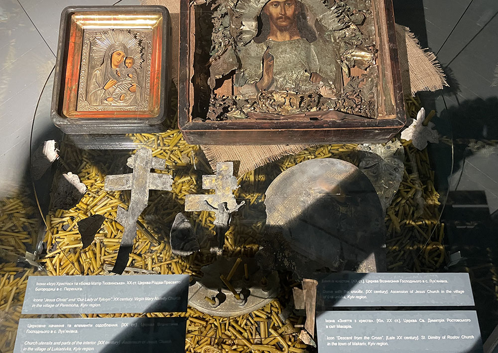 Damaged icons and crucifixes sit atop Russian bullets at the "Ukraine Crucifixion" exhibit in Kyiv, Ukraine, on Dec. 8. (NCR photo/Christopher White)
