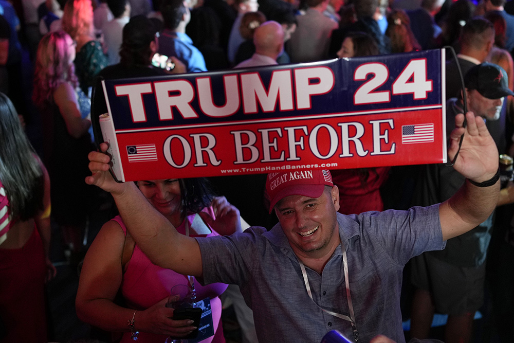 A person holds up a sign before incumbent Florida Republican Gov. Ron DeSantis speaks to supporters during an election night party in Tampa, Florida, Nov. 8, 2022. (AP/Rebecca Blackwell)