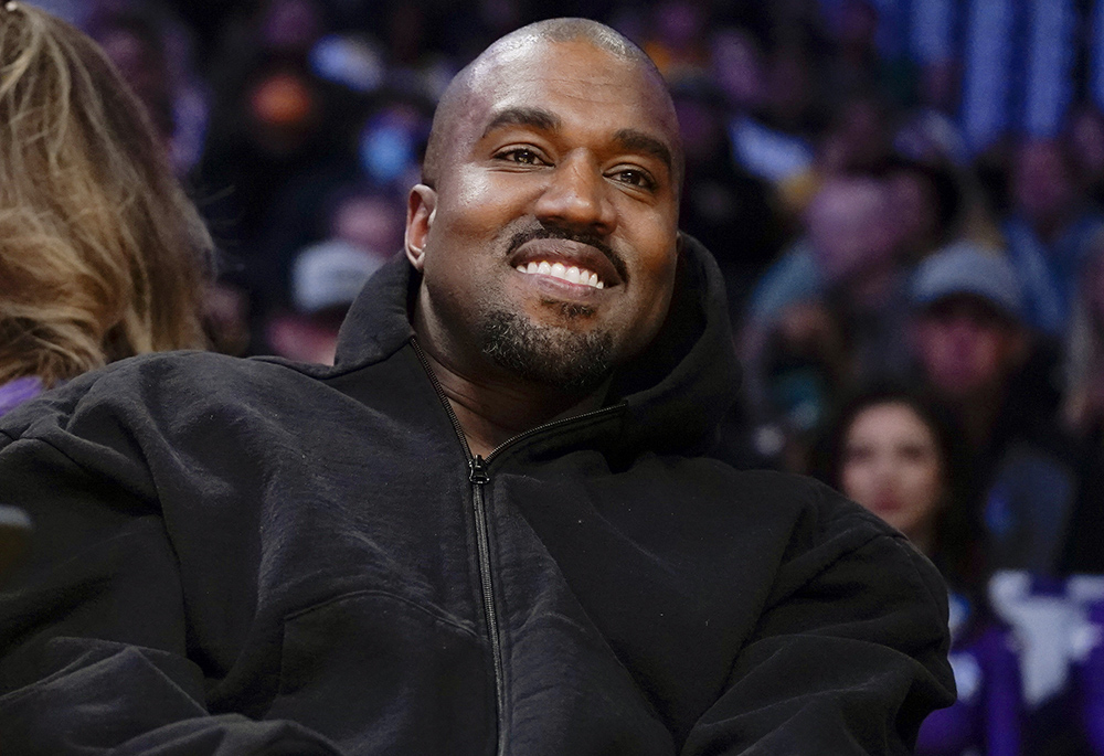 Kanye West watches the first half of an NBA basketball game between the Washington Wizards and the Los Angeles Lakers March 11 in Los Angeles. Former President Donald Trump had dinner Tuesday, Nov. 22, at his Mar-a-Lago club with the rapper formerly known as Kanye West, who is now known as Ye, as well as Nick Fuentes, a far-right activist who has used his online platform to spew antisemitic and white supremacist rhetoric. (AP photo/Ashley Landis, file)