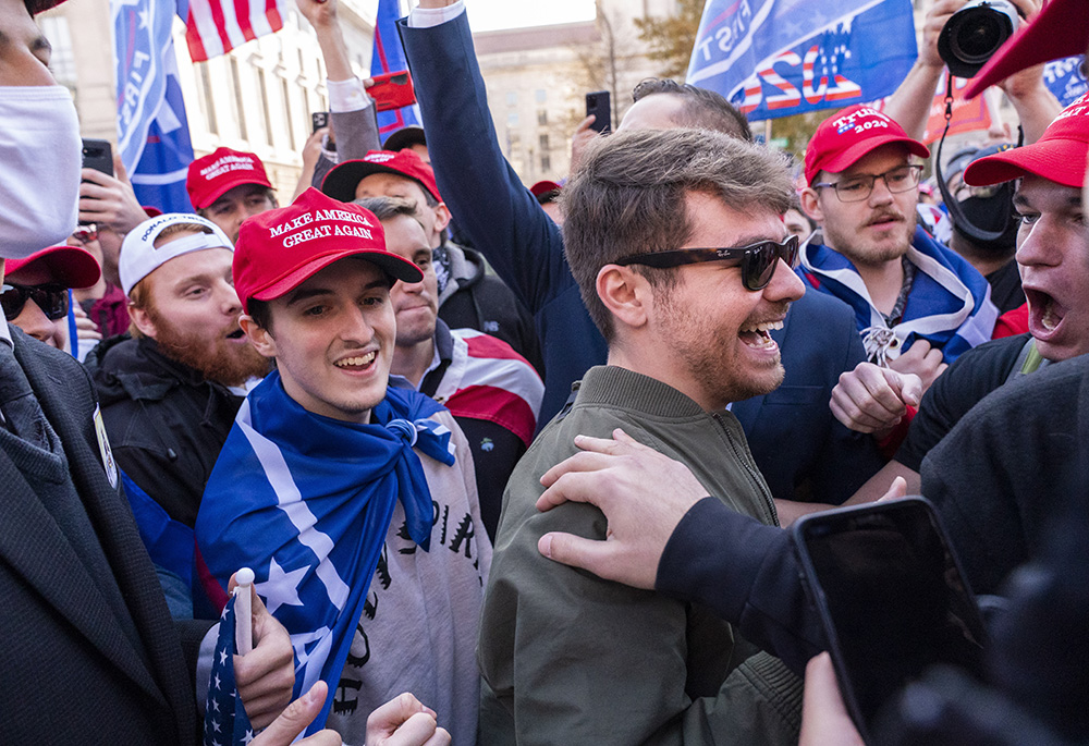 Nick Fuentes right-wing podcaster, center right in sunglasses, greets supporters before speaking at a pro-Trump march, Nov. 14, 2020, in Washington. Former President Donald Trump had dinner Nov. 22 at his Mar-a-Lago club with the rapper formerly known as Kanye West, who is now known as Ye, as well as Nick Fuentes, who has used his online platform to spew antisemitic and white supremacist rhetoric. (AP photo/Jacquelyn Martin, file)