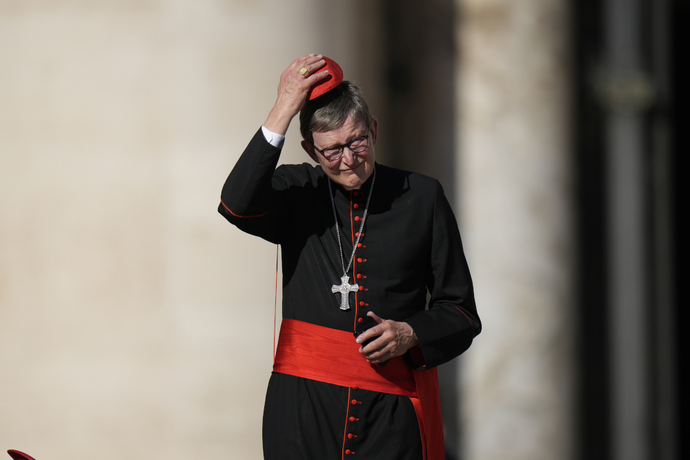 Cardinal Rainer Maria Woelki adjusts his red zucchetto