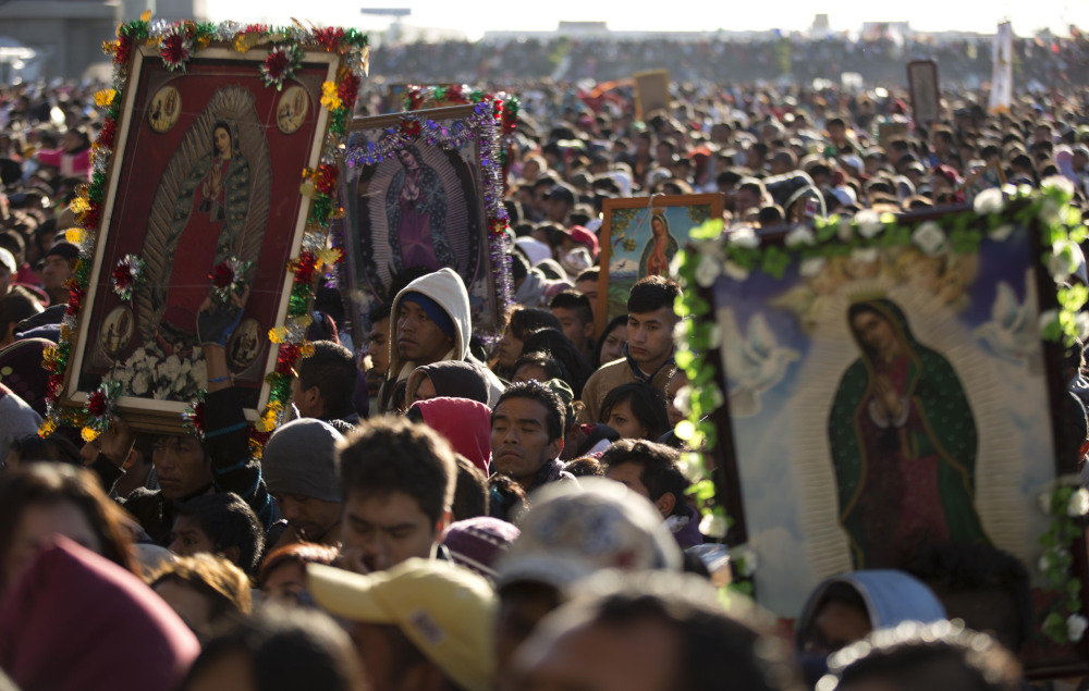 Pilgrims wait their turn to enter the Basilica of Guadalupe, in Mexico City, Dec. 12, 2013. (AP Photo/Eduardo Verdugo, File)