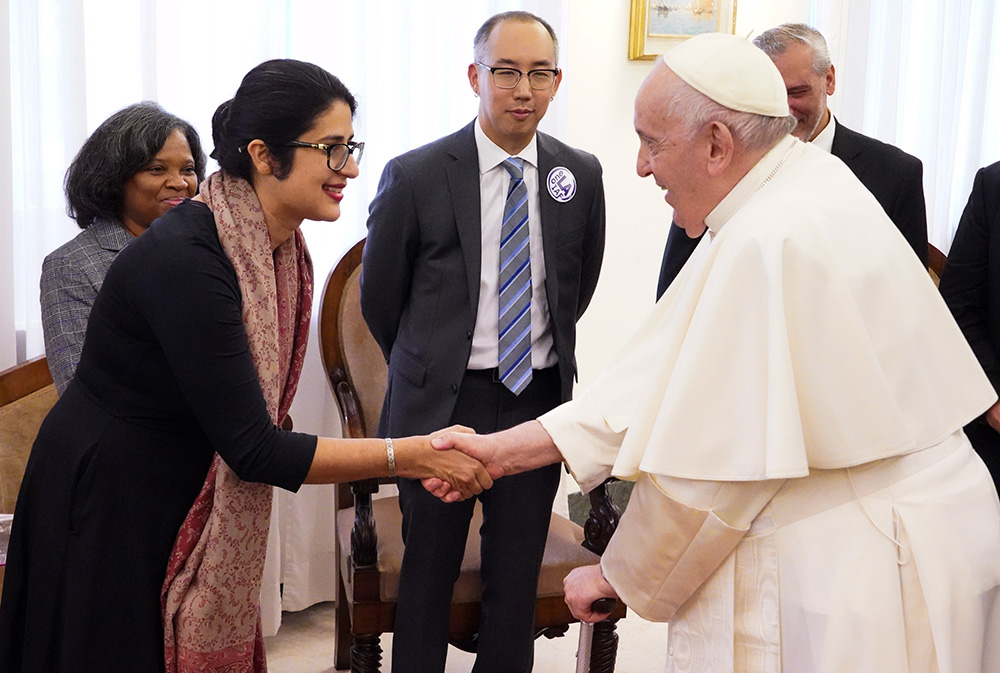 Surya Kalra, lead organizer with EPISO/Border Interfaith of El Paso, Texas, is greeted by Pope Francis in his residence, the Domus Sanctae Marthae, in Rome this fall. Robert Hoo, lead organizer with One LA-IAF in California, looks on. Kalra and Hoo were part of an interfaith delegation of 20 community organizers and leaders who met with the pope and received encouragement for their work in the synod and for their longtime organizing efforts. (Courtesy of West/Southwest Industrial Areas Foundation)