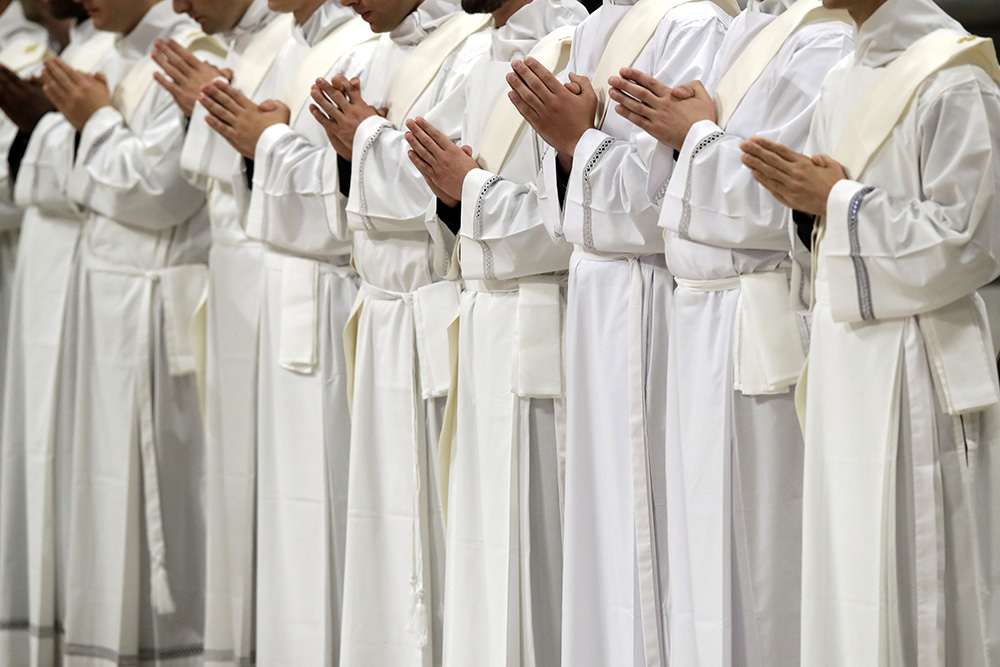 Newly ordained priests pray during a ceremony led by Pope Francis in St. Peter’s Basilica at the Vatican on May 12, 2019. (RNS/AP/Alessandra Tarantino)